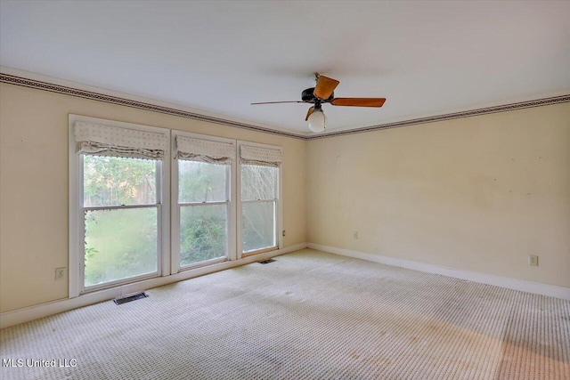 223 Hannah Dr, Clinton, MS 39056 - empty room featuring plenty of natural light, light colored carpet, baseboards, a ceiling fan, and crown molding