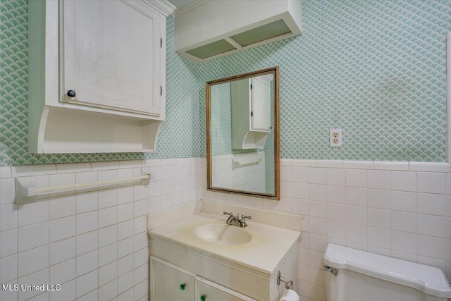 223 Hannah Dr, Clinton, MS 39056 - half bathroom with toilet, wallpapered walls, vanity, a wainscoted wall, and tile walls
