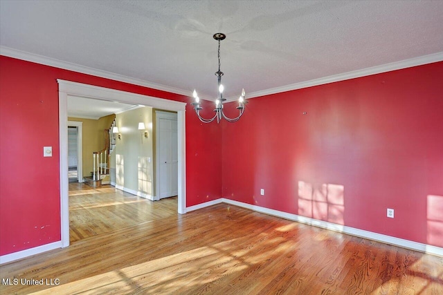 223 Hannah Dr, Clinton, MS 39056 - spare room with wood finished floors, a chandelier, baseboards, and ornamental molding