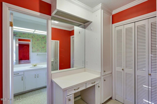 223 Hannah Dr, Clinton, MS 39056 - bathroom featuring a closet, vanity, crown molding, and wallpapered walls