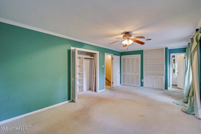 223 Hannah Dr, Clinton, MS 39056 - unfurnished bedroom with carpet flooring, baseboards, ornamental molding, two closets, and ceiling fan