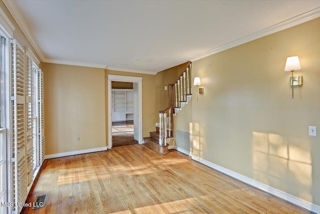 223 Hannah Dr, Clinton, MS 39056 - unfurnished living room with wood finished floors, stairway, baseboards, and crown molding