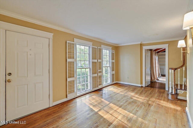 223 Hannah Dr, Clinton, MS 39056 - spare room featuring baseboards, light wood-style floors, crown molding, and stairway