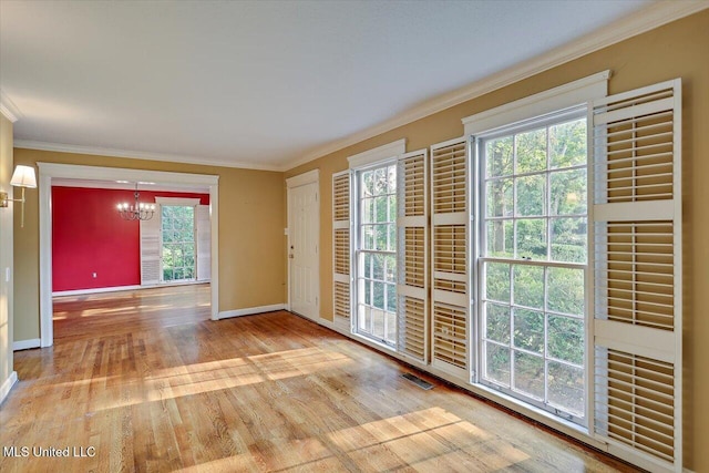 223 Hannah Dr, Clinton, MS 39056 - doorway to outside featuring a chandelier, ornamental molding, baseboards, and wood finished floors