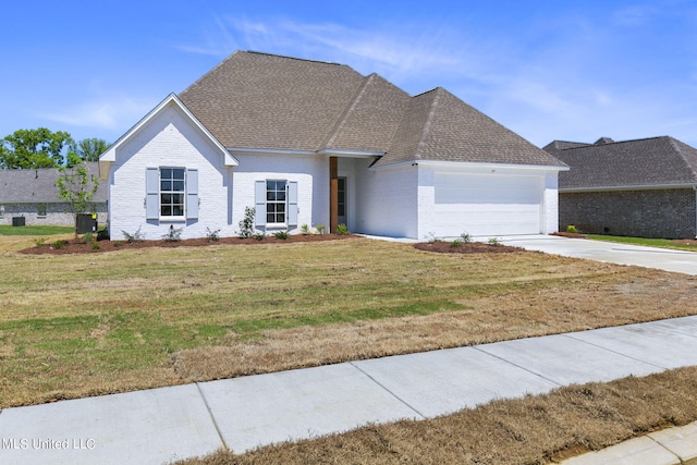 view of front of home featuring a front yard, a garage, and central air condition unit