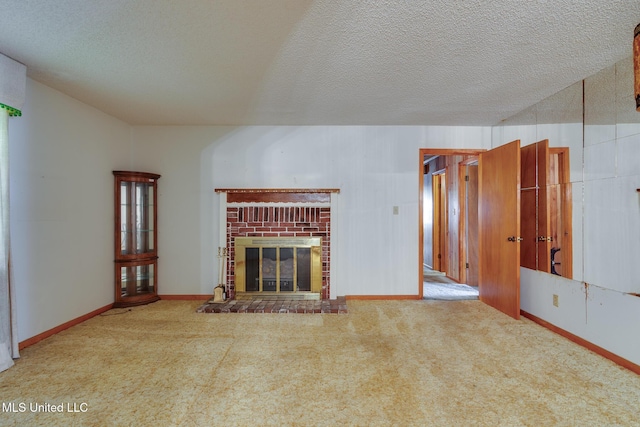 512 Saint Paul Ave, Senatobia, MS 38668 - unfurnished living room featuring carpet, a textured ceiling, and a fireplace