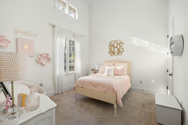 bedroom with light carpet and a towering ceiling