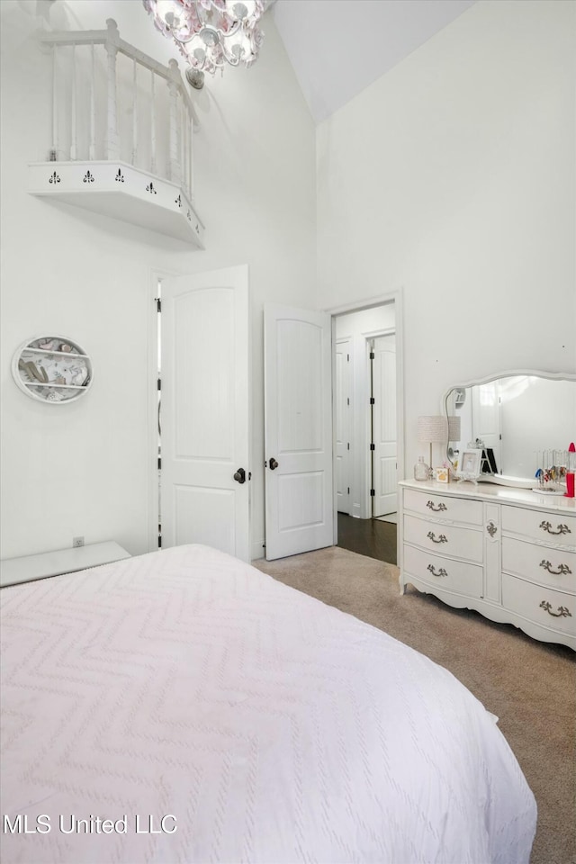 carpeted bedroom featuring high vaulted ceiling