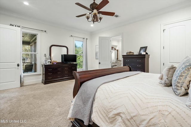 carpeted bedroom with ceiling fan and ornamental molding