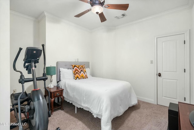 carpeted bedroom with ceiling fan and crown molding