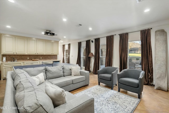 tiled living room featuring crown molding