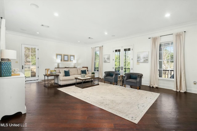 living room featuring french doors, dark wood-type flooring, crown molding, and a healthy amount of sunlight