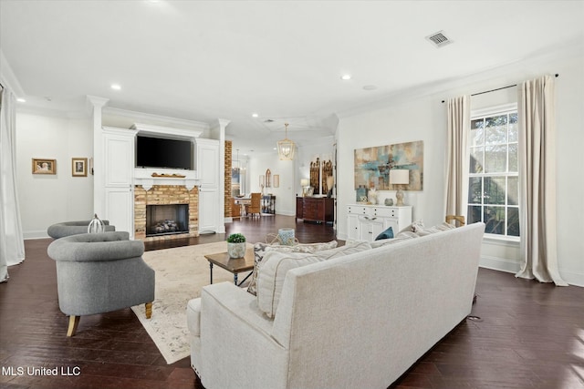 living room featuring crown molding, a fireplace, and dark hardwood / wood-style floors