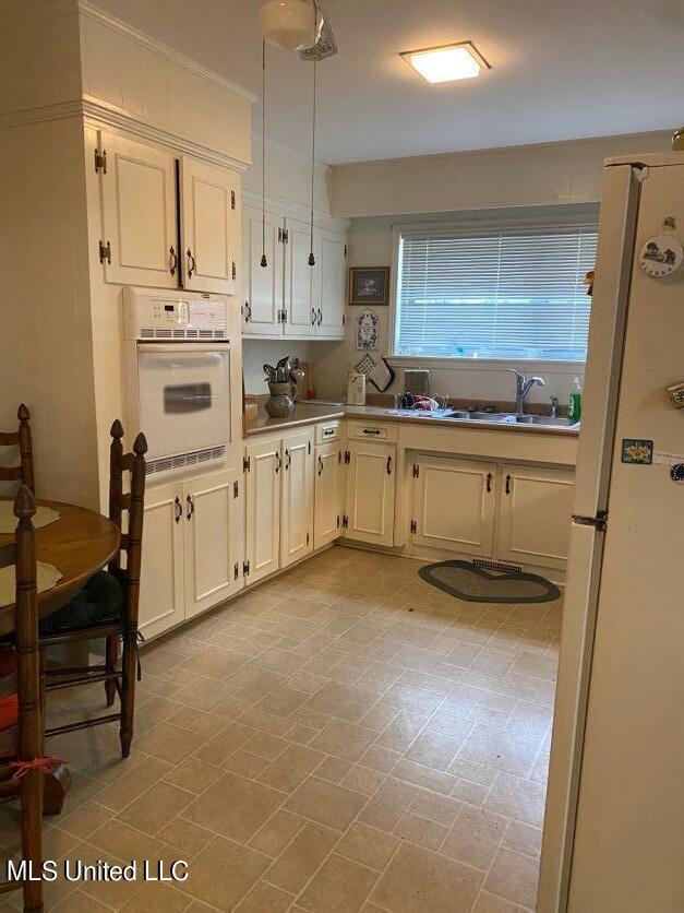 22 N Joliffe St, Eupora, MS 39744 - kitchen with white appliances and a sink