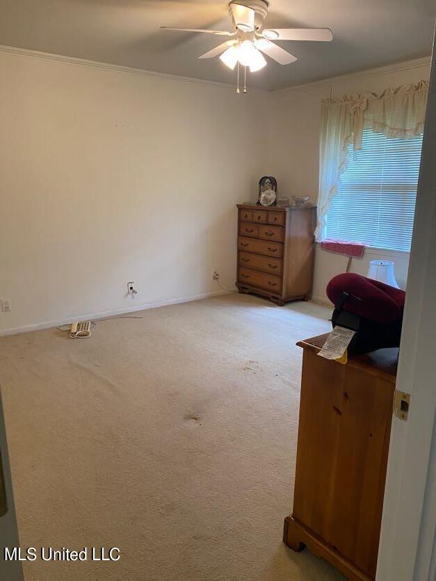 22 N Joliffe St, Eupora, MS 39744 - bedroom featuring a ceiling fan, baseboards, light carpet, and ornamental molding
