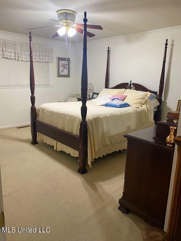 22 N Joliffe St, Eupora, MS 39744 - carpeted bedroom featuring crown molding and a ceiling fan