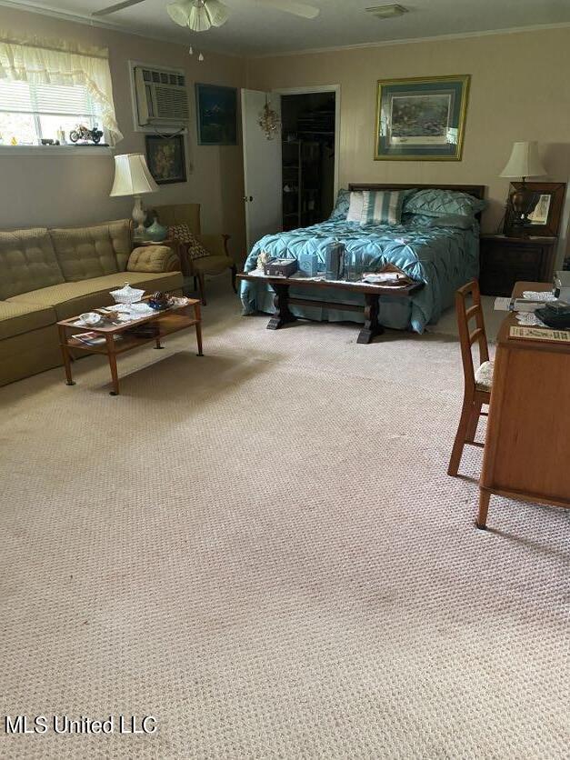 22 N Joliffe St, Eupora, MS 39744 - carpeted bedroom featuring crown molding and a wall unit AC