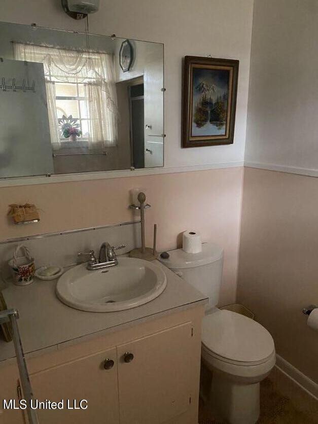22 N Joliffe St, Eupora, MS 39744 - half bathroom with vanity and toilet