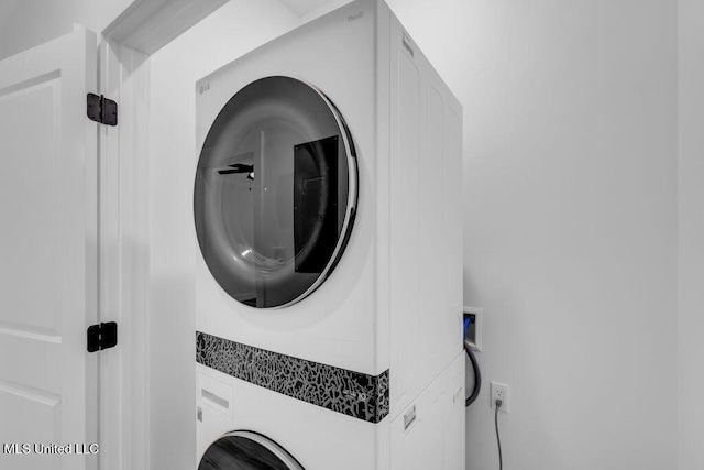 laundry room with stacked washer / dryer and laundry area