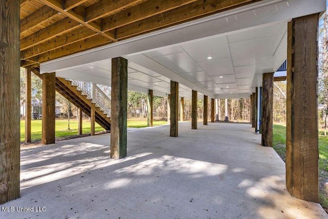 view of patio / terrace featuring stairs and a carport