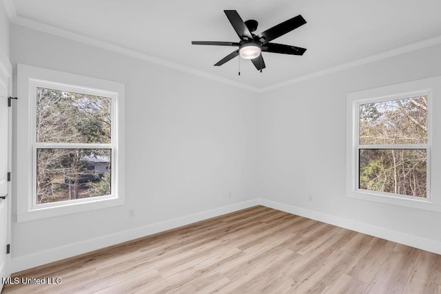 spare room featuring light wood finished floors, baseboards, ornamental molding, and ceiling fan