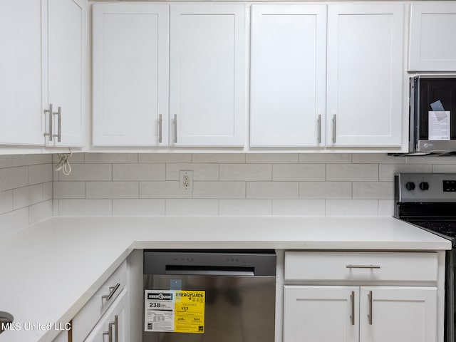 kitchen featuring stainless steel appliances, decorative backsplash, and white cabinets