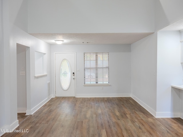 foyer featuring a textured ceiling and hardwood / wood-style floors