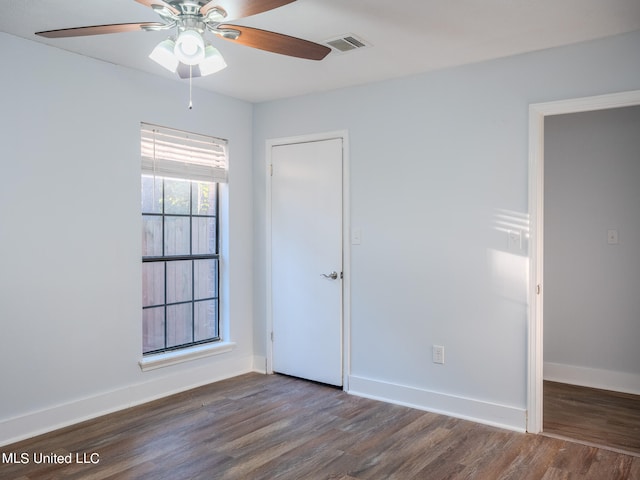 unfurnished room featuring ceiling fan and dark hardwood / wood-style floors