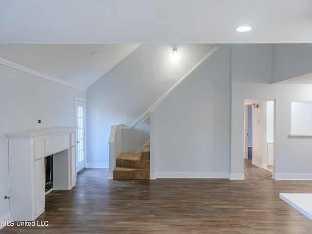 unfurnished living room with vaulted ceiling and dark hardwood / wood-style flooring