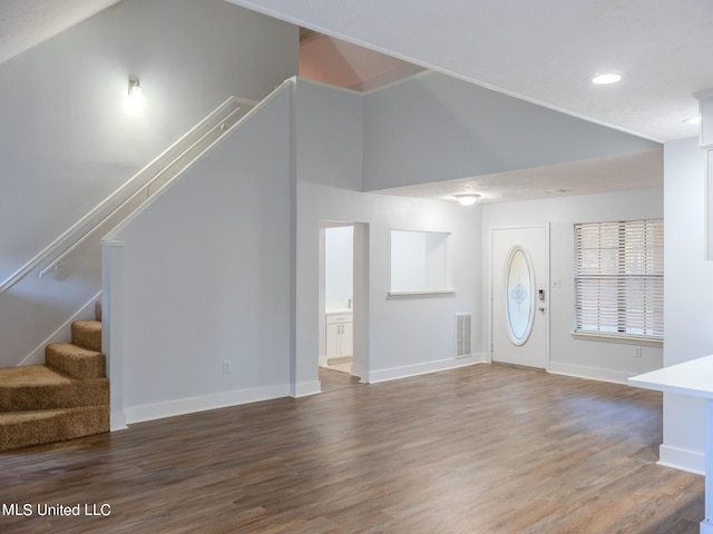 foyer with high vaulted ceiling and hardwood / wood-style flooring