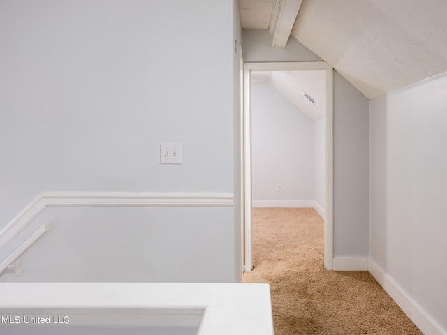 interior space featuring lofted ceiling with beams