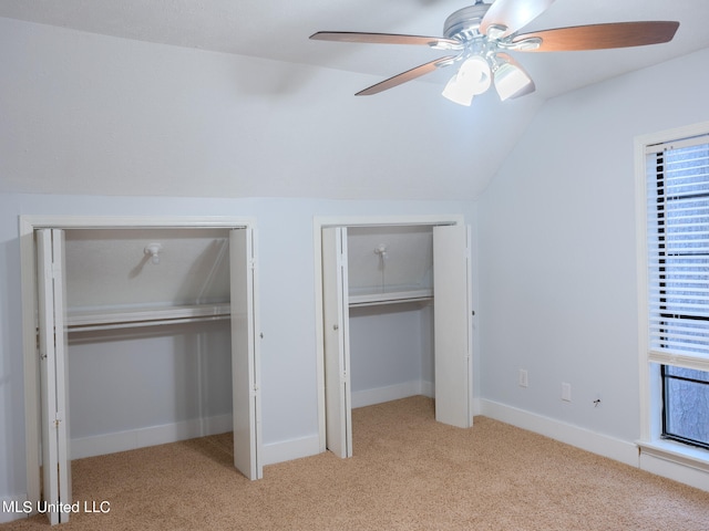 unfurnished bedroom featuring lofted ceiling, light carpet, and ceiling fan