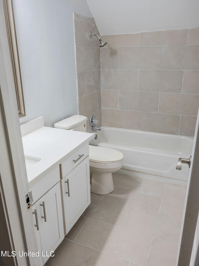 full bathroom with vanity, tiled shower / bath, toilet, and tile patterned floors