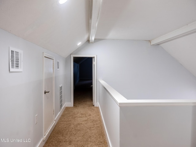 hallway with light carpet and lofted ceiling with beams