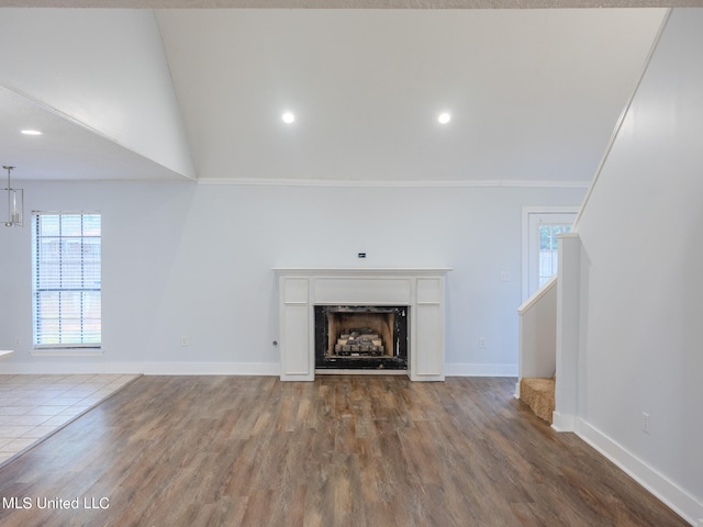 unfurnished living room featuring crown molding and hardwood / wood-style flooring