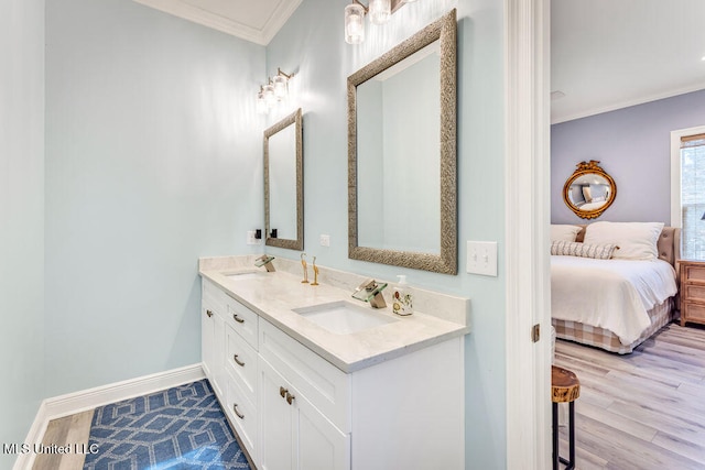 bathroom featuring vanity, ornamental molding, and hardwood / wood-style floors