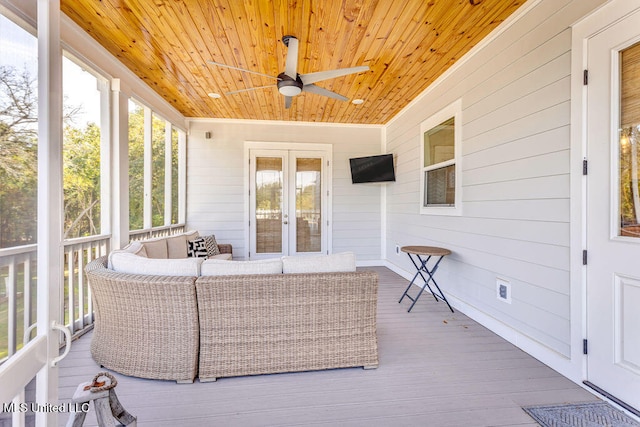 sunroom / solarium with ceiling fan, a healthy amount of sunlight, and wooden ceiling