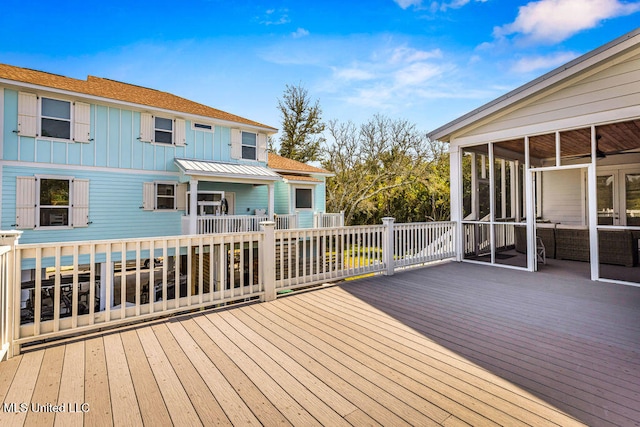 wooden deck featuring a sunroom