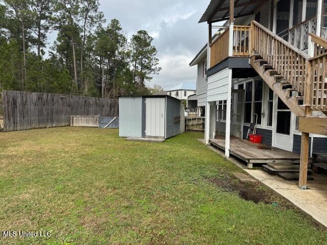 view of yard with a storage shed and a deck