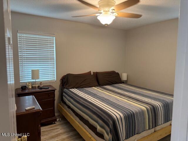 bedroom featuring ceiling fan and light hardwood / wood-style floors