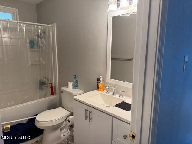 full bathroom with vanity, toilet, and shower / tub combo with curtain