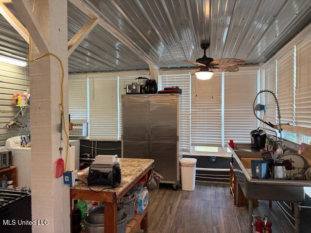 misc room with ceiling fan and dark hardwood / wood-style floors