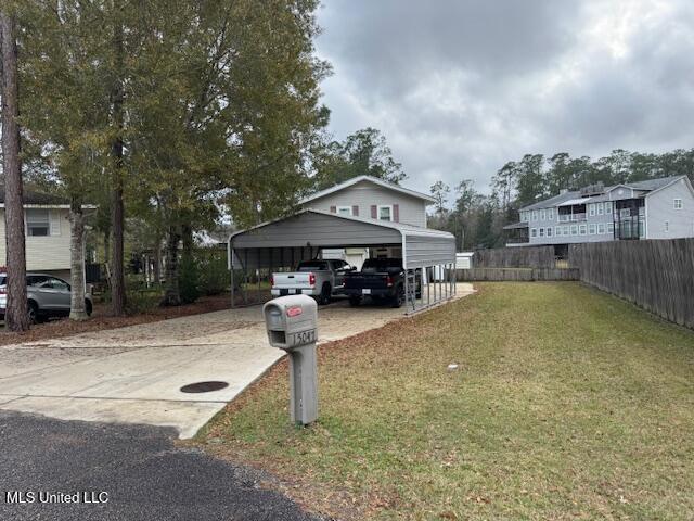 exterior space with a carport and a front yard