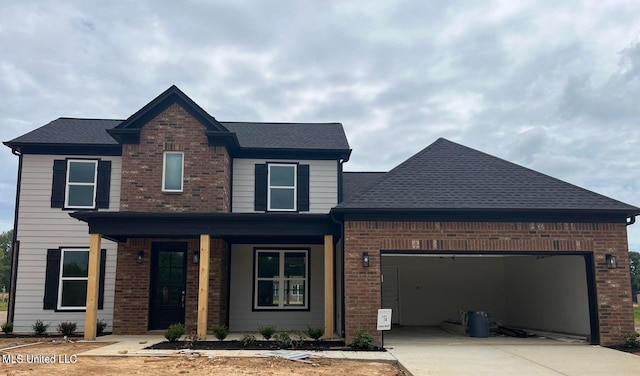 front of property featuring covered porch and a garage