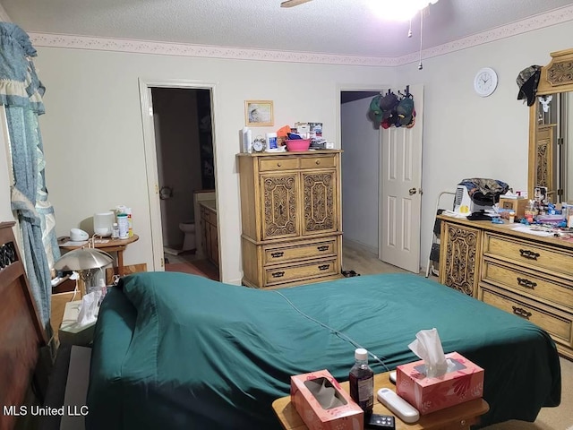 bedroom featuring light carpet, a textured ceiling, and connected bathroom
