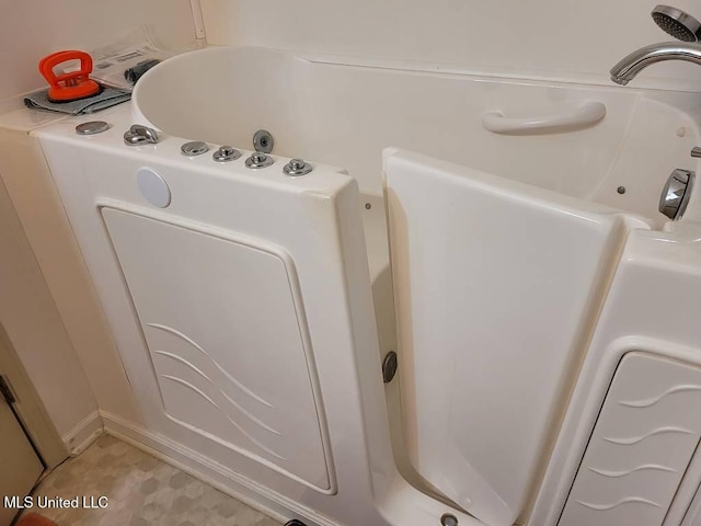 interior space featuring a tub with jets