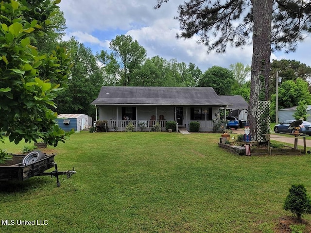 view of front of property with a porch, an outdoor structure, a front yard, and a storage unit