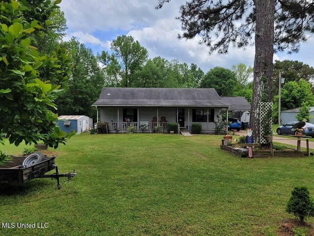 3189 S Red Banks Rd, Byhalia, MS 38611 - view of front of property with a porch, an outdoor structure, a front yard, and a storage unit
