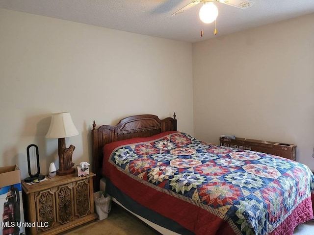 bedroom featuring a ceiling fan and carpet
