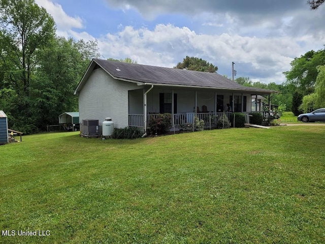 exterior space featuring a porch, a yard, and cooling unit